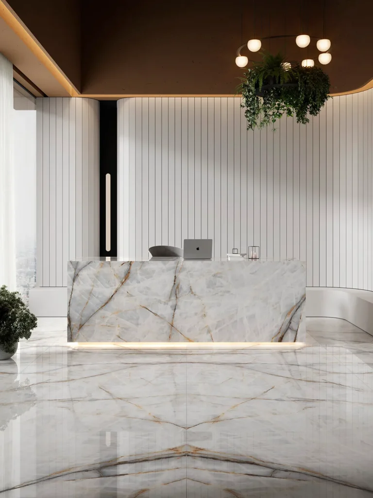 Mostrador de recepción moderno en Aura Lux White, piedra sinterizada de Ascale, con vetas elegantes que atraviesan la piedra blanca como hilos dorados y ahumados. Un diseño que combina modernidad y sofisticación, transmitiendo lujo y personalidad al espacio.